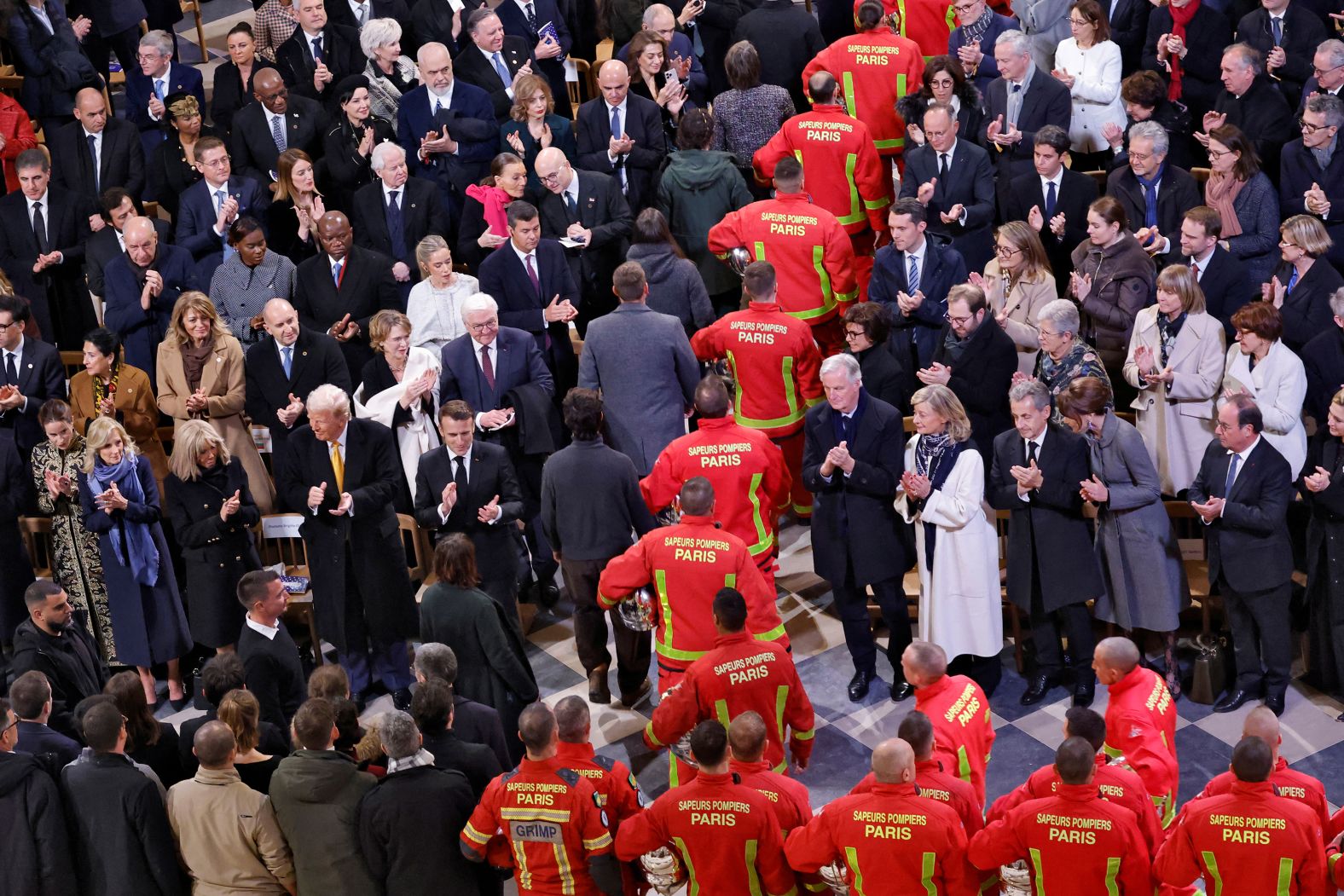 Firefighters, rescuers and builders involved in the restoration walk through the nave past attendees, including US President-elect Donald Trump, current US first lady Jill Biden and Britain’s Prince William, as well as other world leaders and dignitaries.