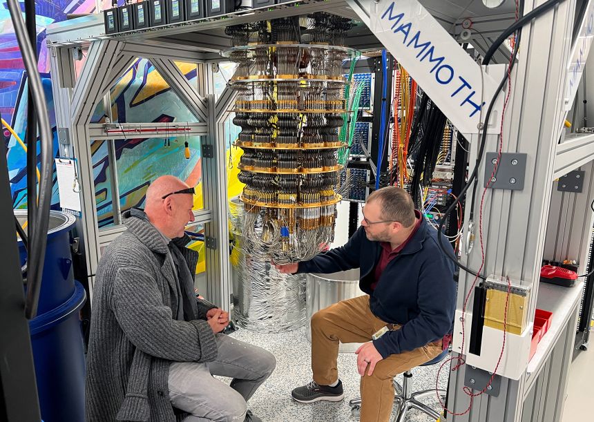 Google Quantum AI's Hartmut Neven, left, and Anthony Megrant examine a cryostat refrigerator for cooling quantum computing chips at Google's Quantum AI lab in Santa Barbara, California, on November 25, 2024.