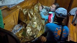 A volunteer assists an 11-year-old girl from Sierra Leone, the sole survivor of a shipwreck off Italy's Lampedusa Island on Wednesday. 