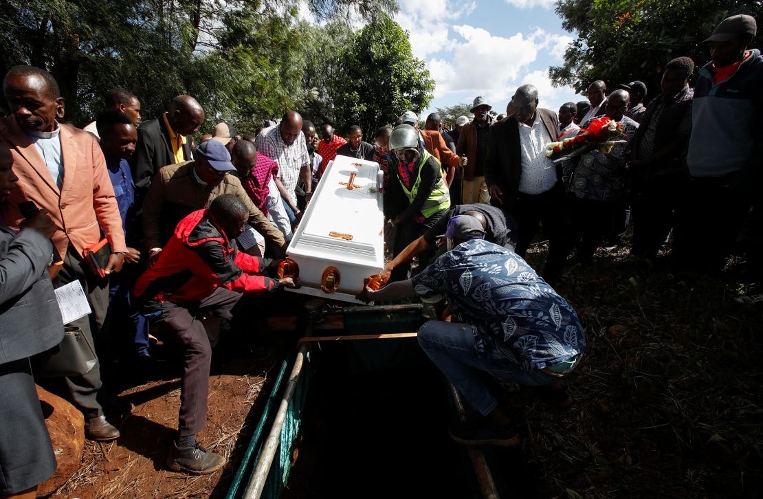 Pallbearers in southern Kenya's Kajiado County lower the coffin of 30-year-old Rose Soila, whose body was discarded in a bush after being raped and murdered in November 2024.