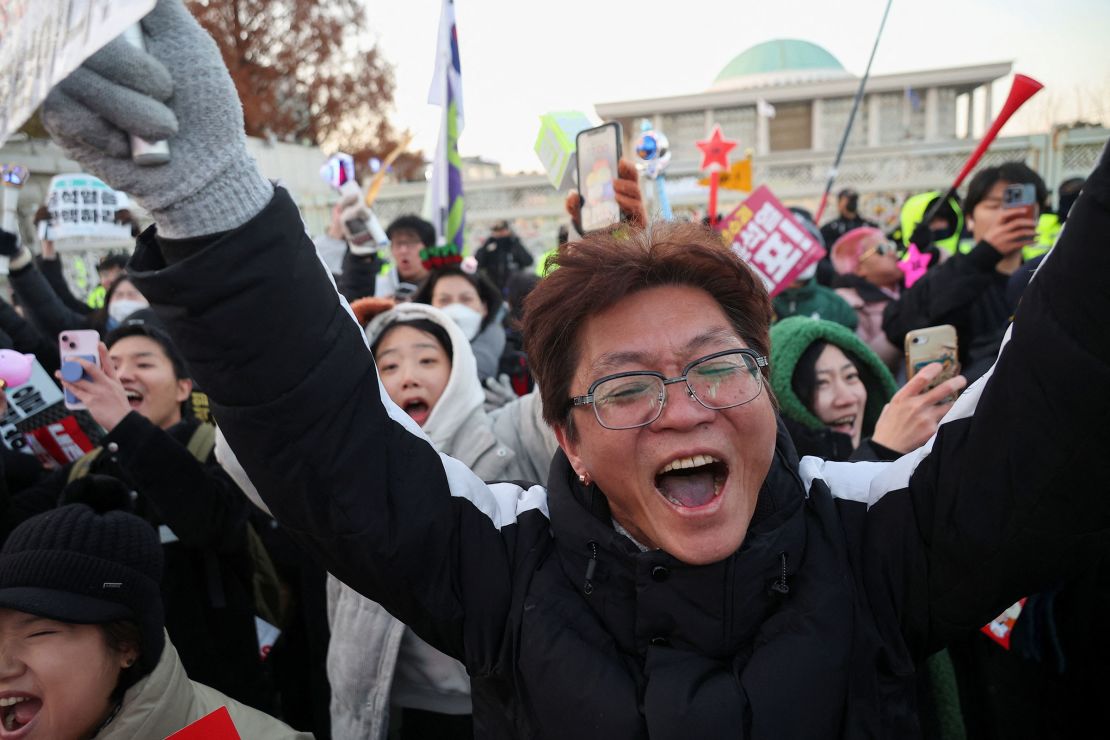 People celebrate after the South Korean parliament passed an impeachment motion against Yoon on December 14.