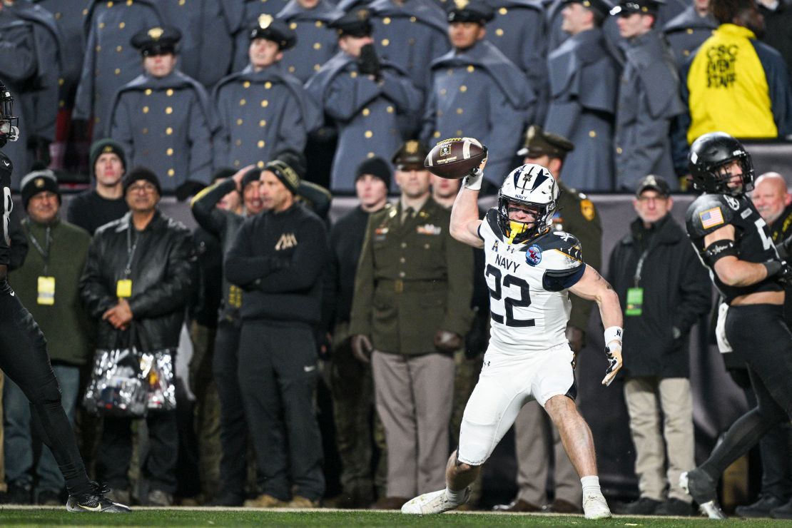 Navy's Eli Heidenreich (No. 22) celebrates after scoring a third quarter touchdown.