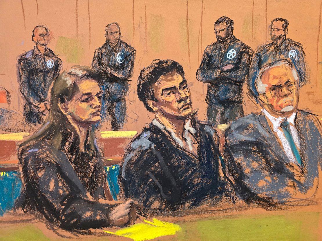 Luigi Mangione sits between his defense attorneys Karen Friedman Agnifilo and her husband Marc Agnifilo during his federal court hearing in New York on Thursday, December 19.