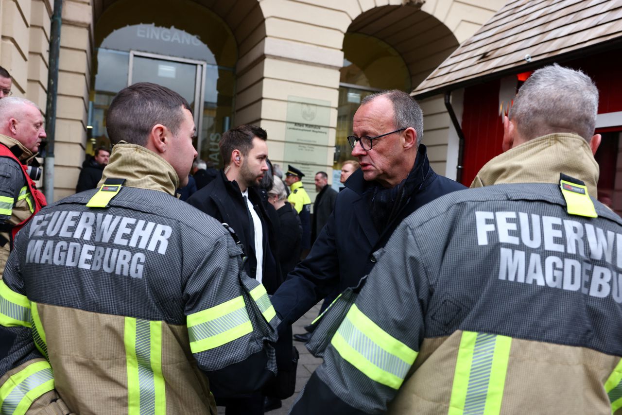 Friedrich Merz, leader of the Christian Democratic Union (CDU), greets rescue workers as he visits the Christmas market in Magdeburg, Germany, on December 21.