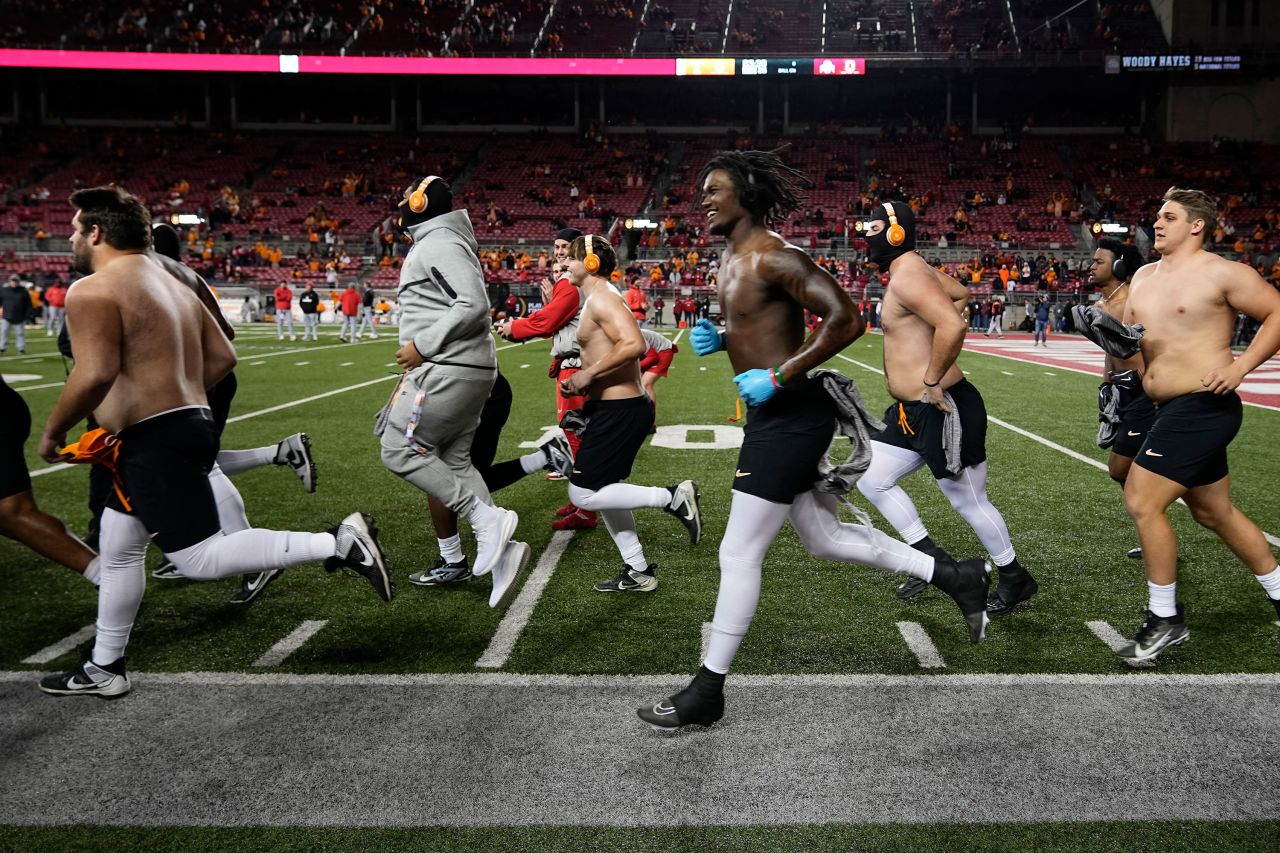 The Tennessee Volunteers take the field for warm ups without shirts in sub-freezing temperatures ahead of their game against Ohio State.