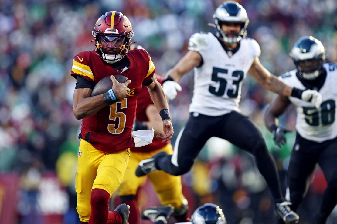 Dec 22, 2024; Landover, Maryland, USA; Washington Commanders quarterback Jayden Daniels (5) runs the ball against the Philadelphia Eagles during the third quarter at Northwest Stadium. Mandatory Credit: Peter Casey-Imagn Images