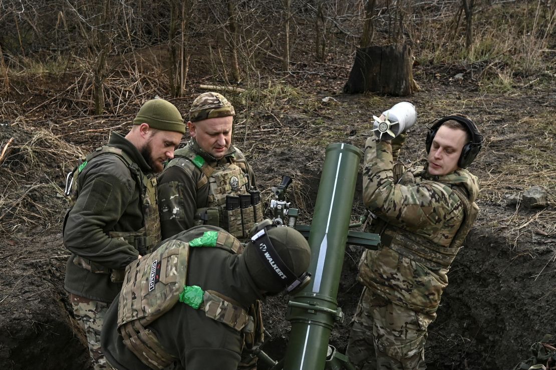 Ukrainian troops prepare to fire a mortar towards Russian forces near the eastern Ukrainian town of Toretsk on December 20.