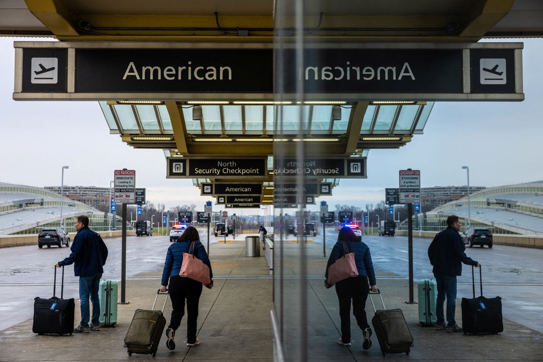 Travellers arrive for departing flights as American Airlines resumed its flights after a technical glitch forced the carrier to issue an hour-long ground stop, disrupting travel for thousands on Christmas Eve, one of the busiest periods of the year, at Ronald Reagan Washington National Airport in Arlington, Virginia, U.S. December 24, 2024. REUTERS/Anna Rose Layden