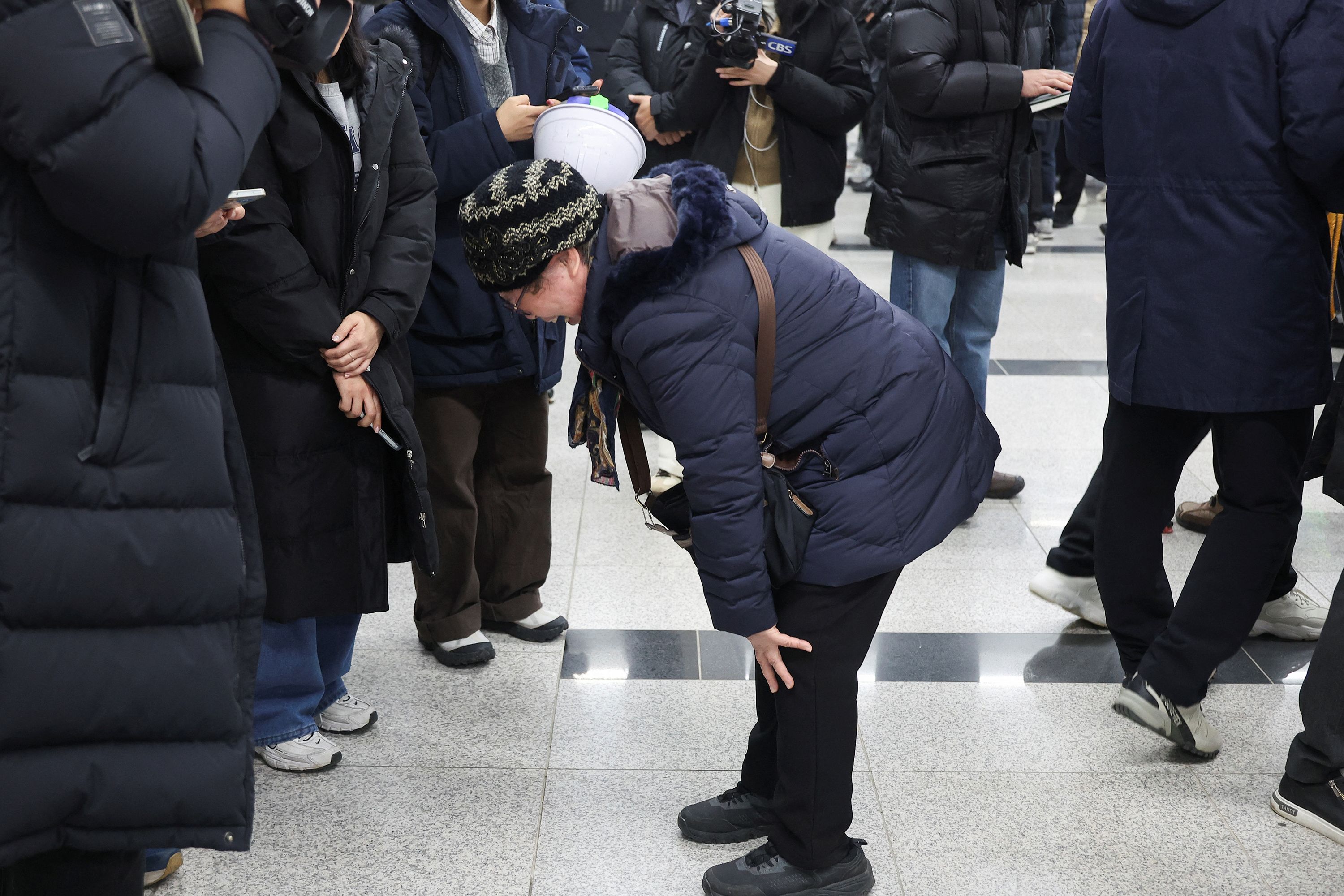 A relative of a passenger that was on the plane reacts at Muan International Airport on December 29.