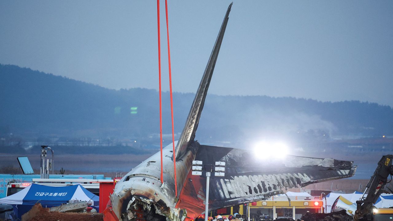 Efforts are made to lift the wreckage of an aircraft lying on the ground after it went off the runway and crashed at Muan International Airport, in Muan, South Korea, on December 29, 2024.