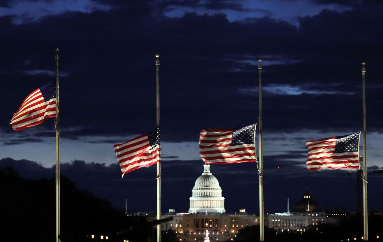 Flags fly at half-staff at the Washington Monument on the National Mall on December 30.