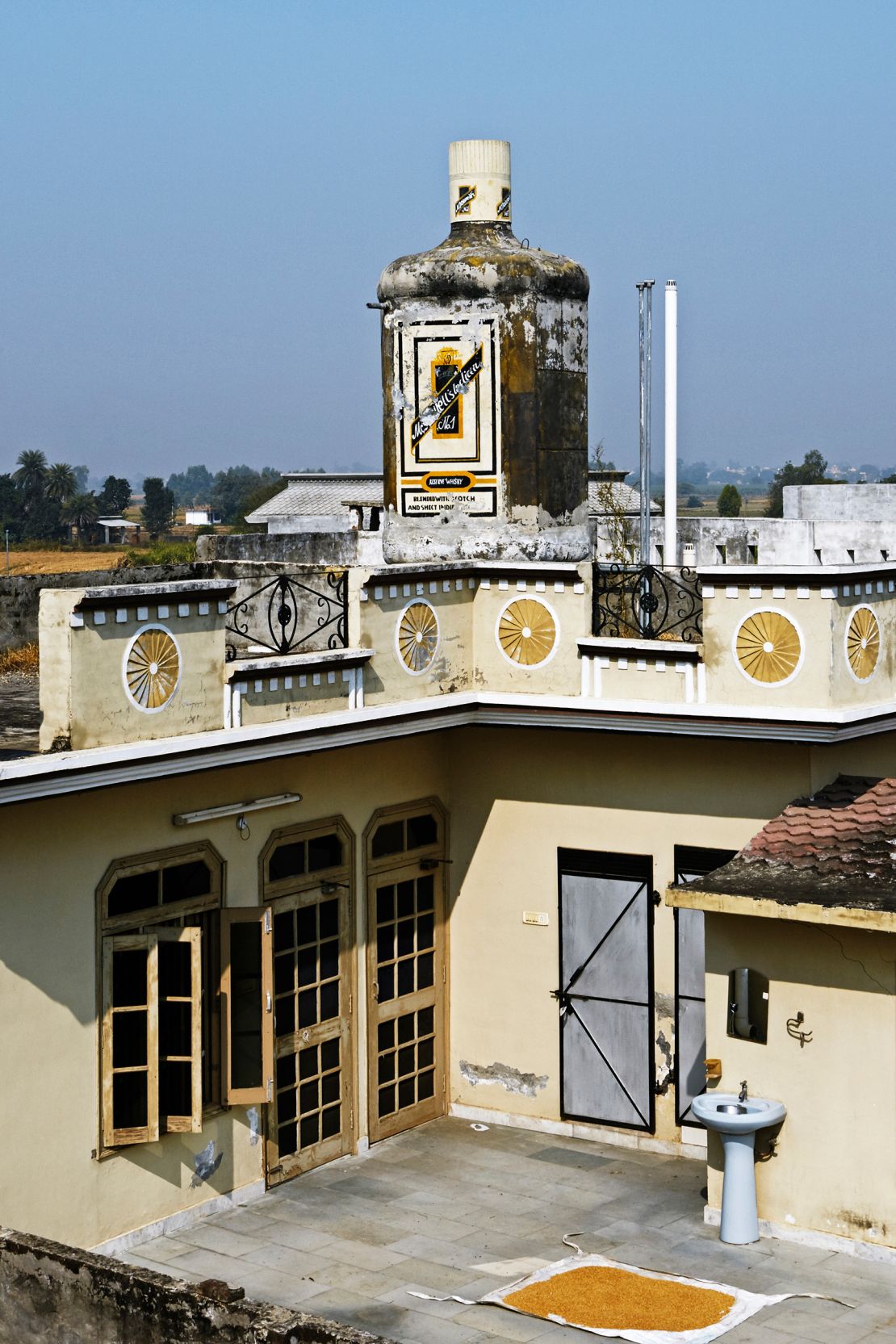 A whiskey bottle sculpture in Jhander Kalan.