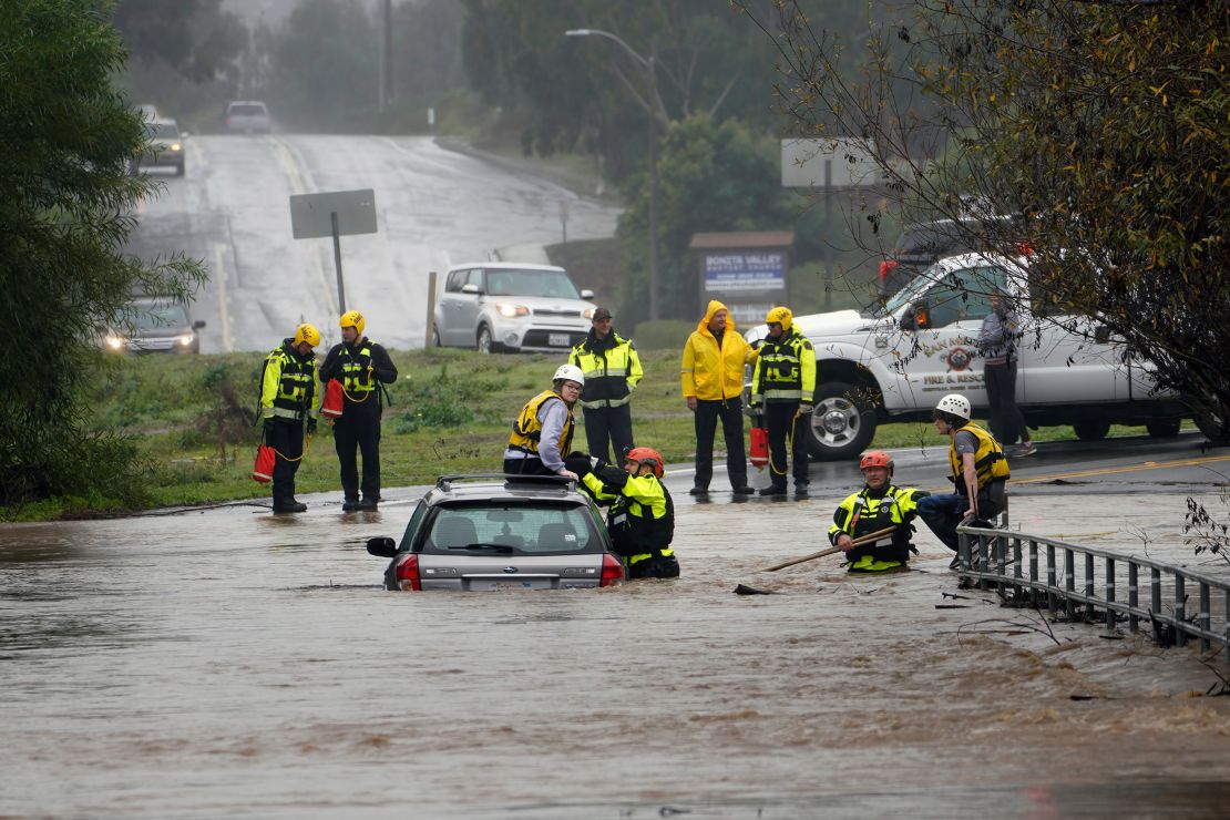  Emergency personnel rescued two individuals trapped on a flooded road in San Diego County.