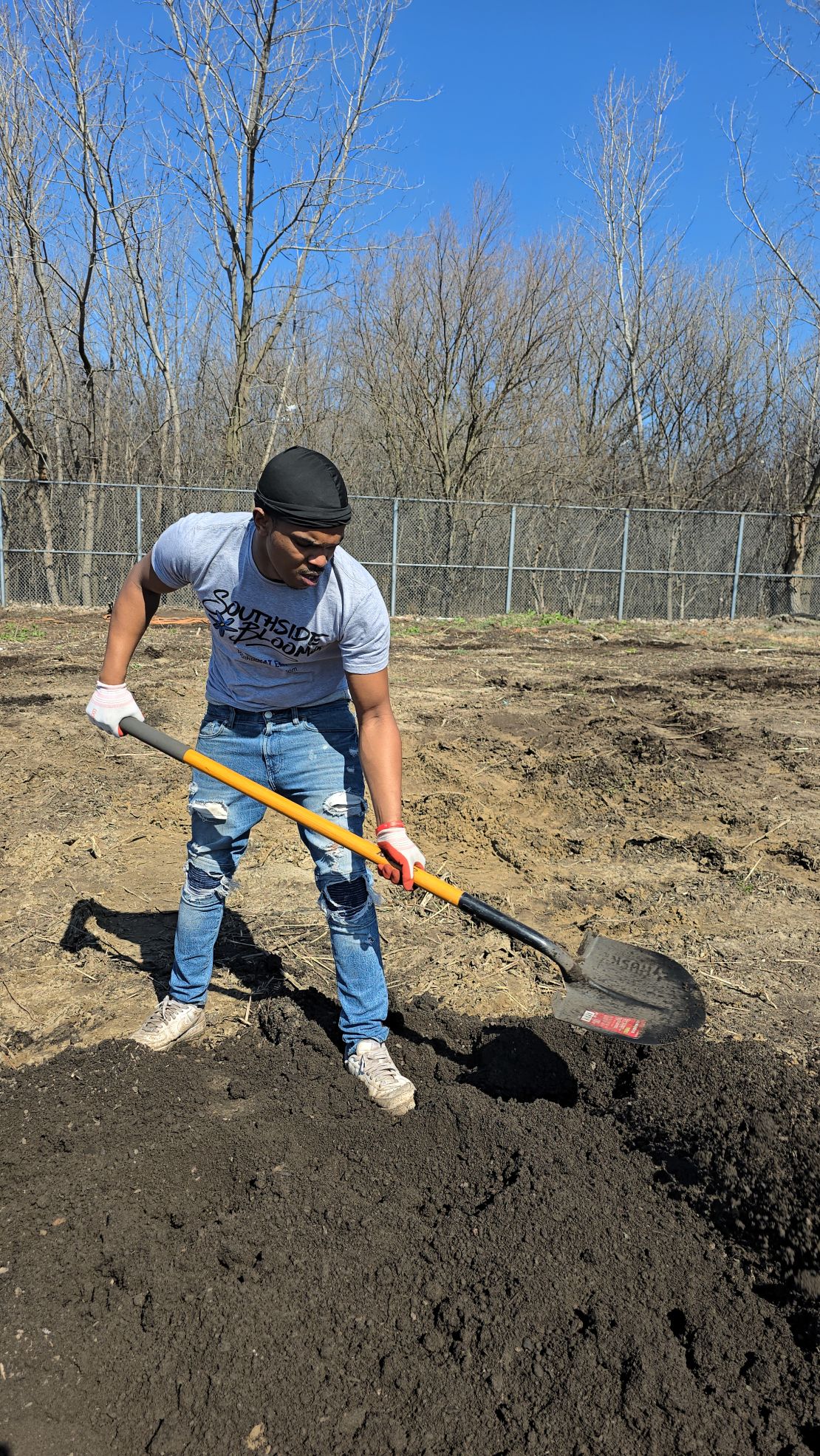 Dionta White works the compost pile at one of Southside Blooms' Chicago flower farms.