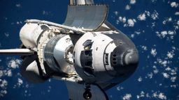 In this handout image from NASA taken by the International Space Station crew, the Space Shuttle Discovery performs a 360 degree flip. )