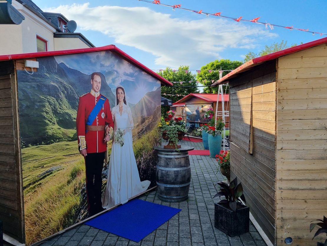 Huts used for the annual Christmas market sport pictures of the royals over classic UK landscapes.