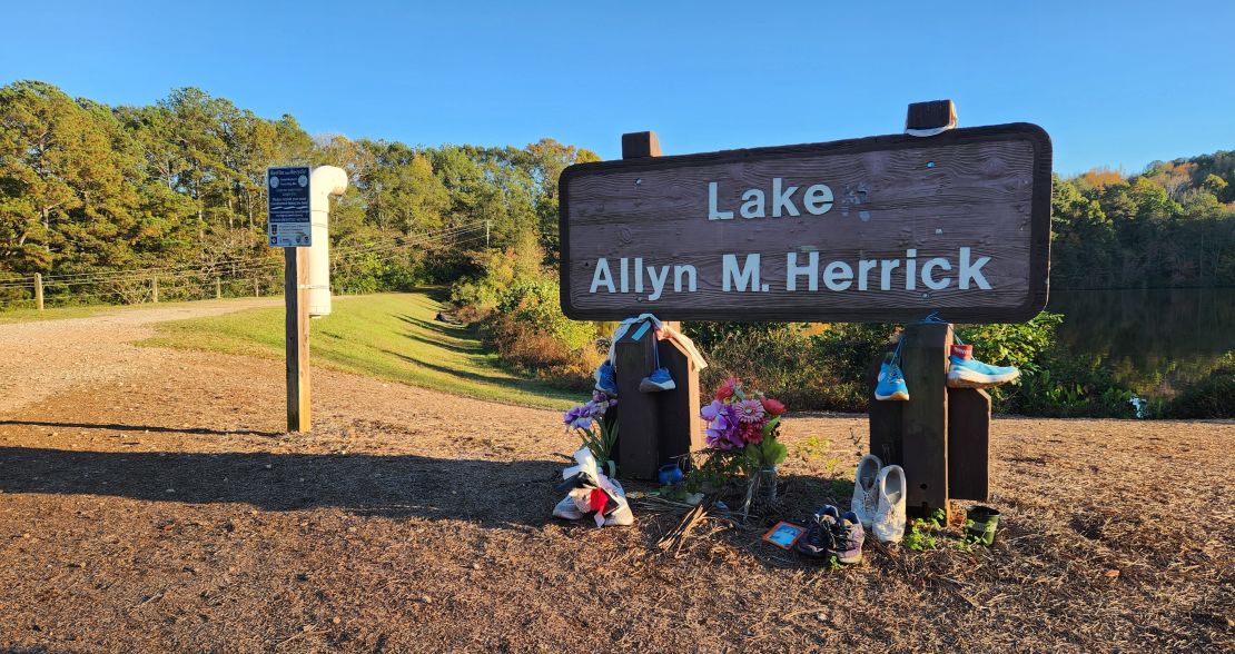 Mourners set up a memorial honoring Laken Riley at the entrance to a trail near where she was killed.