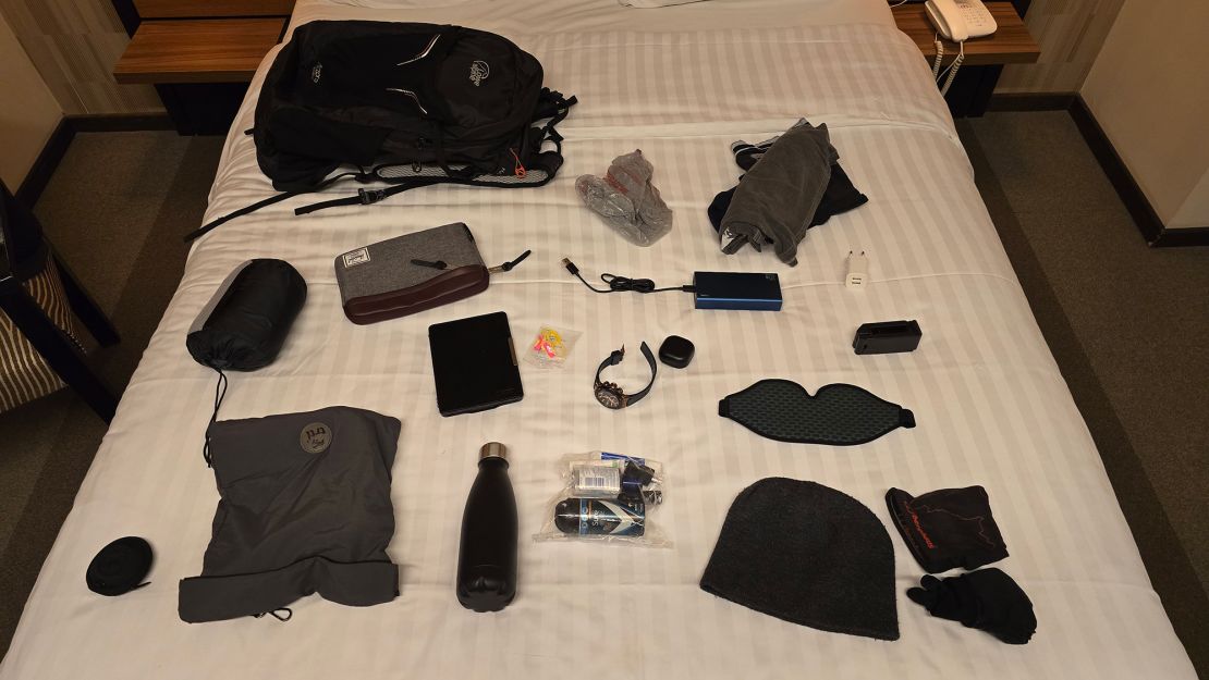 Collins flew hand-luggage only, and put together a kit of essentials including a travel pillow and eye mask for his long overnights in economy.