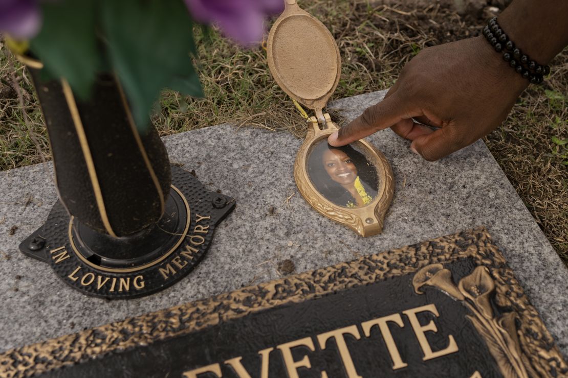 Ngumezi’s husband, Hope, touches his wife’s grave in Pearland, Texas.