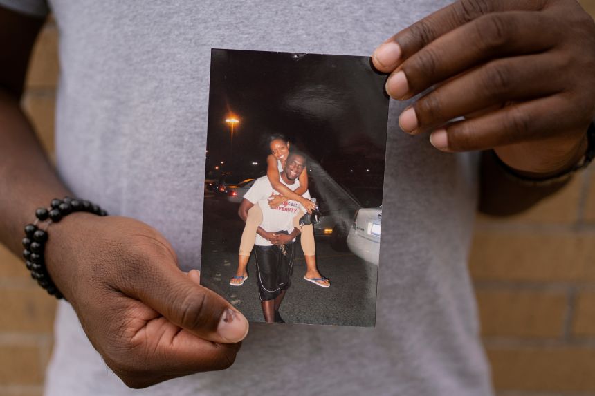 Hope Ngumezi holds a photograph of him and his late wife, Porsha, who died in a Houston hospital during a miscarriage in June 2023.
