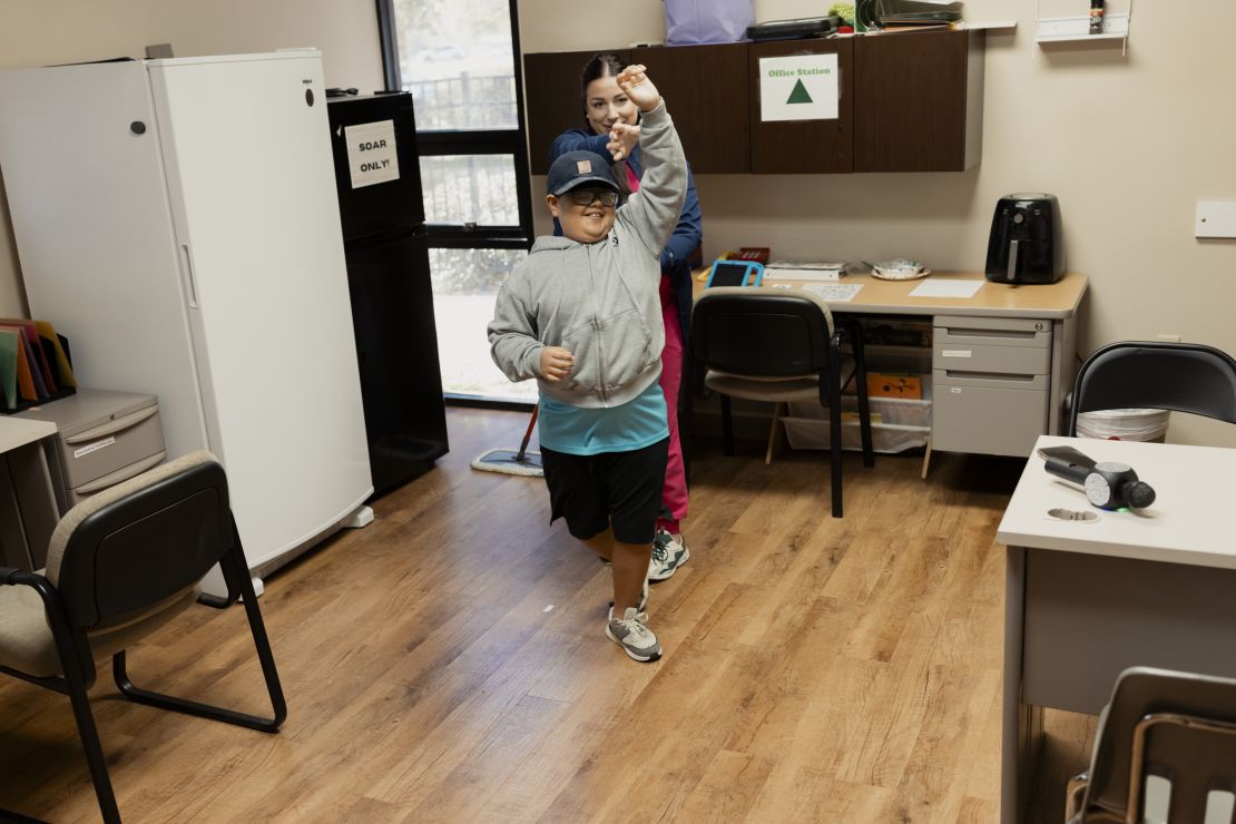 Benji dances with his behavior analyst, Whitney Newton, at Aspire Behavioral Health Center in Lafayette.