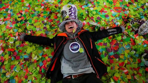 A man lies in confetti after the ball drop in New York's Times Square on January 1, 2025.