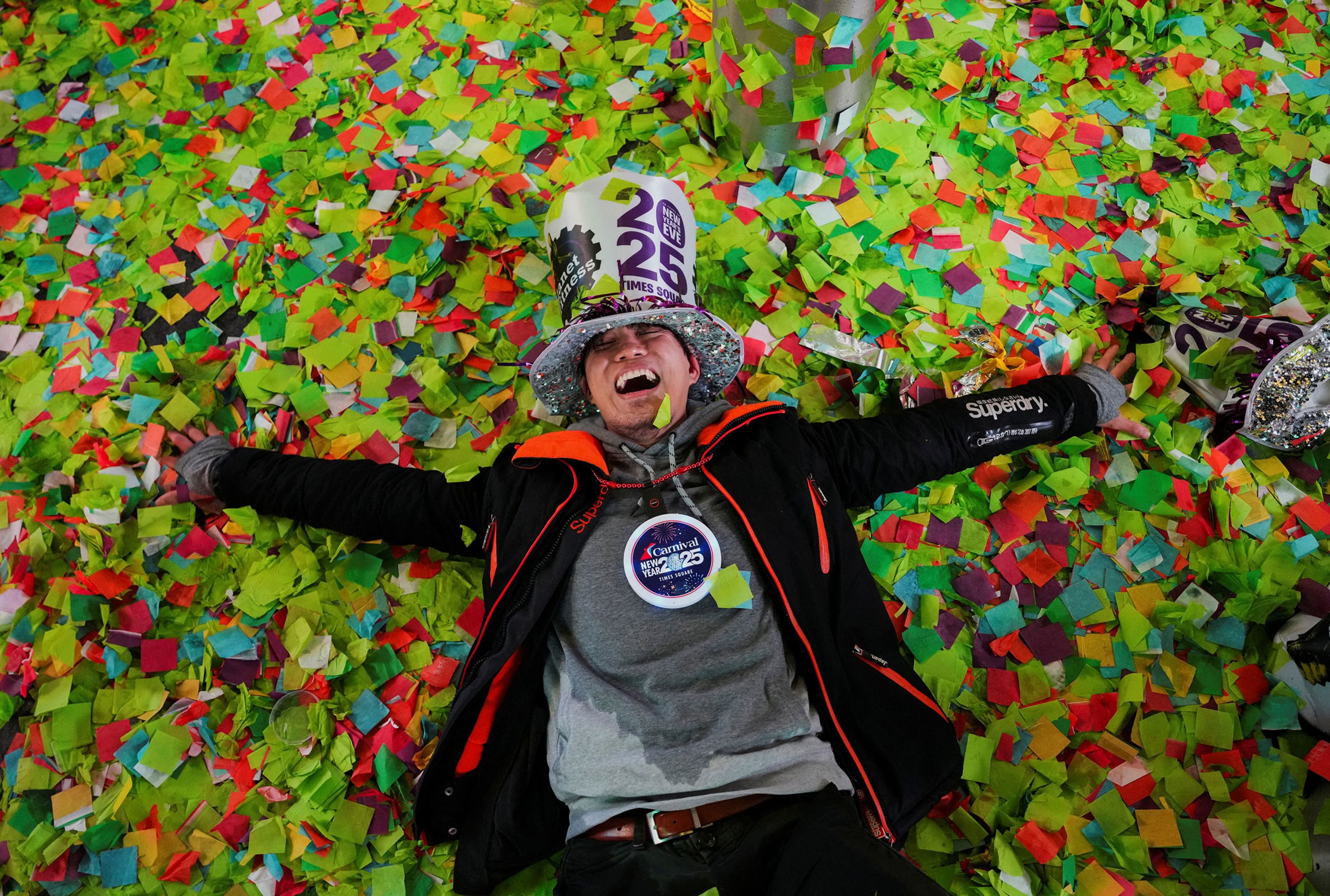 A man lies in confetti after the ball drop in Times Square on January 1.