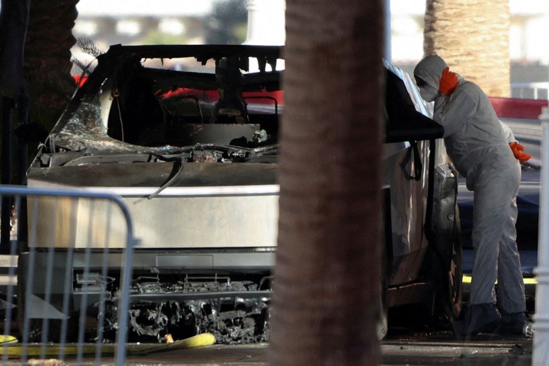 The remains of a Tesla cybertruck that burned at the entrance to Trump Tower are inspected on January 1, 2025 in Las Vegas, Nevada.