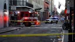 A fire truck and a police vehicle operate near the site where people were killed by a man driving a truck in an attack during New Year's celebrations, in New Orleans, Louisiana, on January 1, 2025.