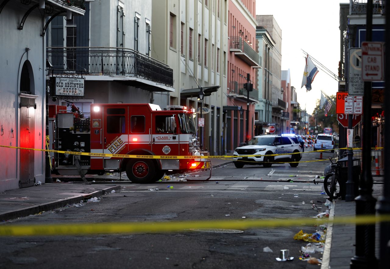 A fire truck and a police vehicle operate near the site where people were killed by a man driving a truck in an attack during New Year's celebrations, in New Orleans, Louisiana, on January 1.