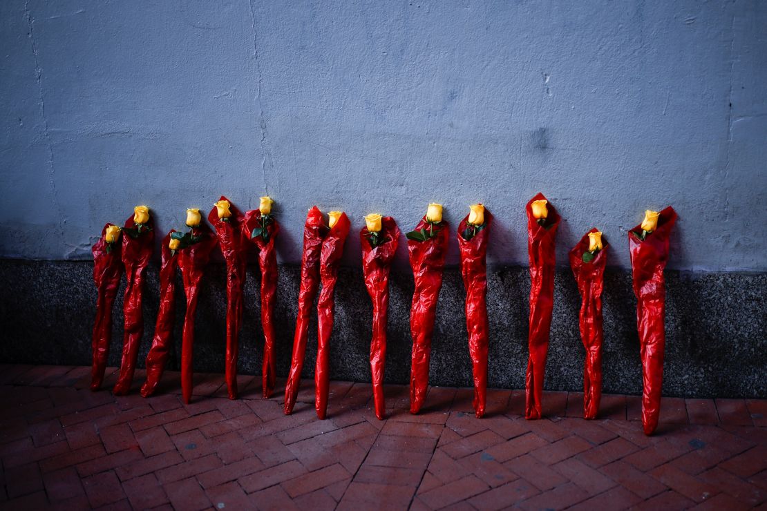 Flowers lean Thursday against a wall near where people were killed by a man driving a truck in New Orleans.