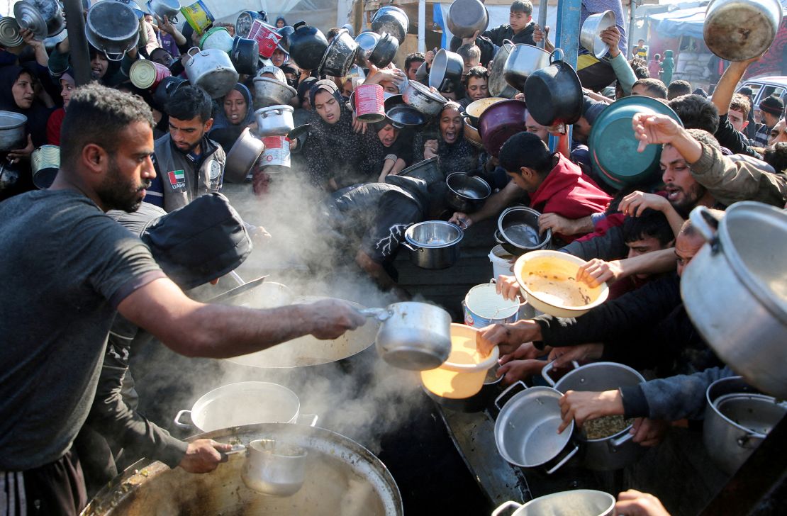 Palestinians gather to receive food cooked by a charity kitchen in Khan Younis on January 2.