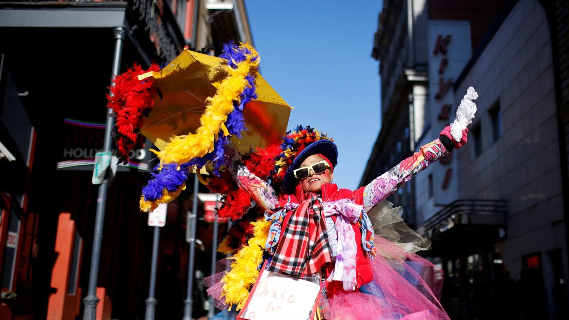 Jennifer Jones of New Orleans dances next to a makeshift memorial for the Bourbon Street victims.