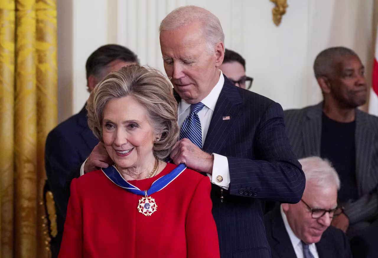 President Joe Biden presents the Presidential Medal of Freedom to Hillary Clinton during a ceremony at the White House, in Washington, DC on January 4.
