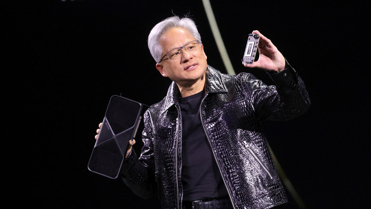 Nvidia CEO Jensen Huang holds a new Nvidia GeForce RTX 5090 graphics card as he gives a keynote address at CES 2025, an annual consumer electronics trade show, in Las Vegas, Nevada, U.S. January 6, 2025.