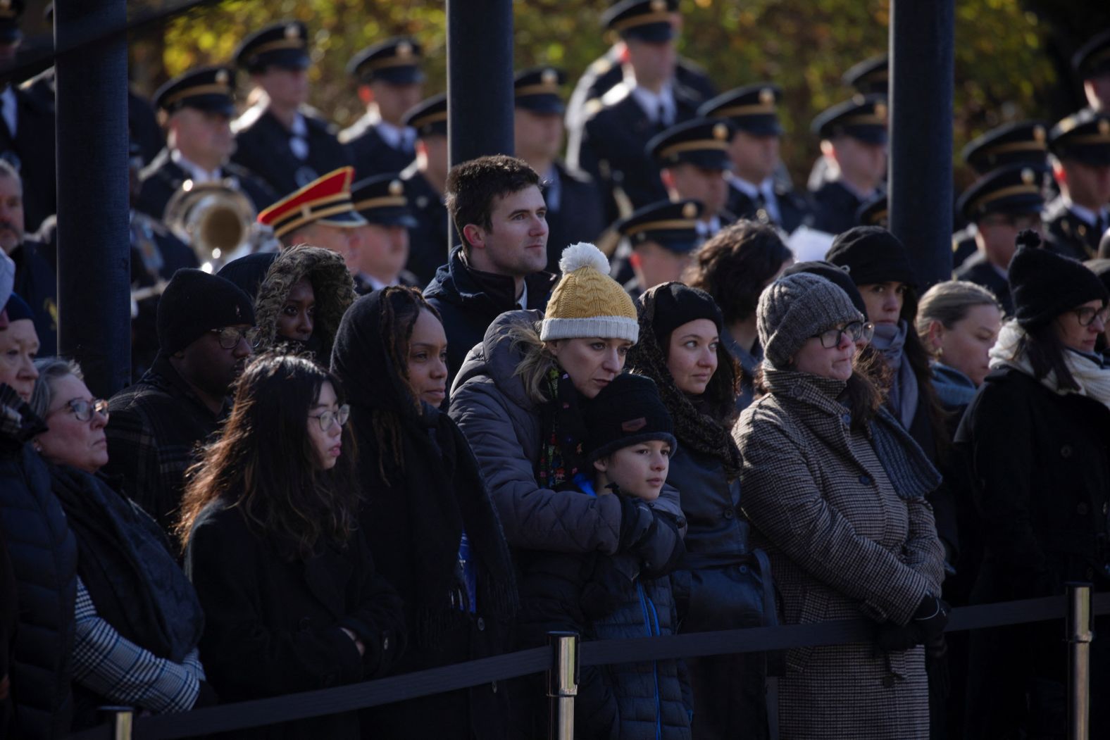 Current and former employees of the Jimmy Carter Presidential Library and Museum watch as Carter's casket is carried from the library in Atlanta on January 7.