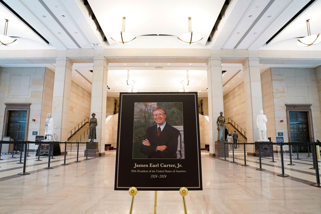 A sign in remembrance of Jimmy Carter, the former president who died on December 29 at the age of 100, is displayed inside the visitor center at the US Capitol building, on the day the casket of Jimmy Carter arrives to lie in state in the Rotunda of the US Capitol building in Washington, on January 7.