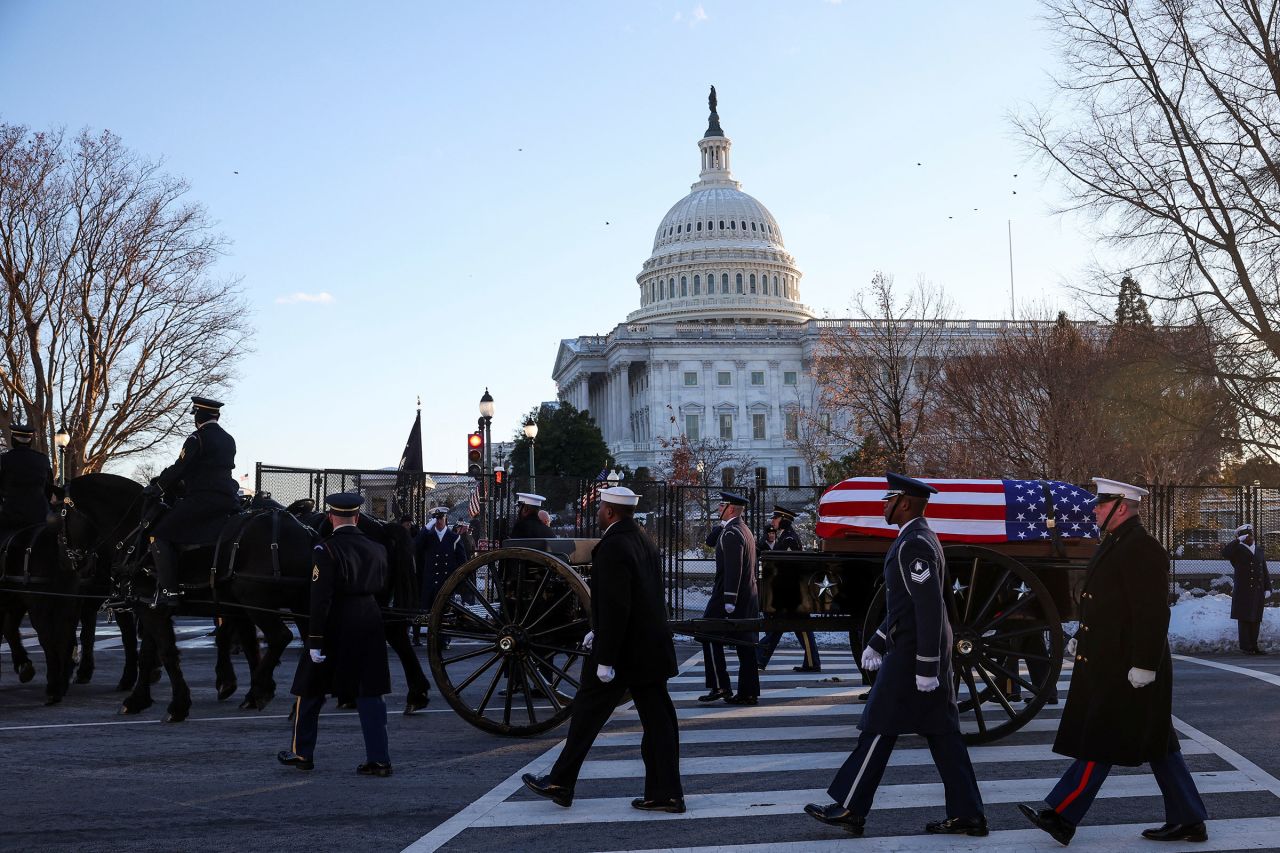 The US Army's Caisson Detachment carries the casket of Jimmy Carter to lie in state at the US Capitol on January 7.