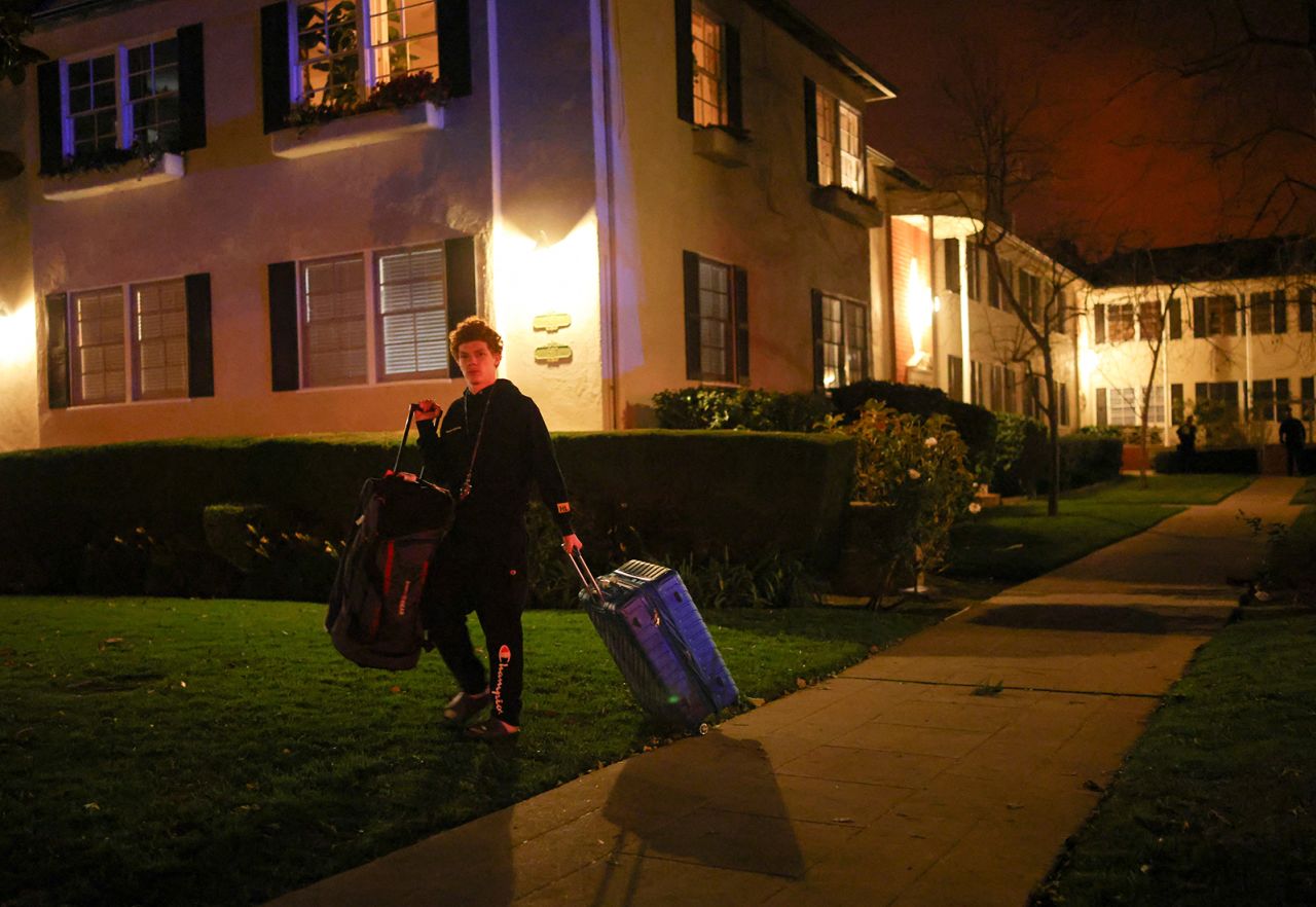 A man leaves following an evacuation order as a wildfire burns in the Pacific Palisades neighborhood on January 7.