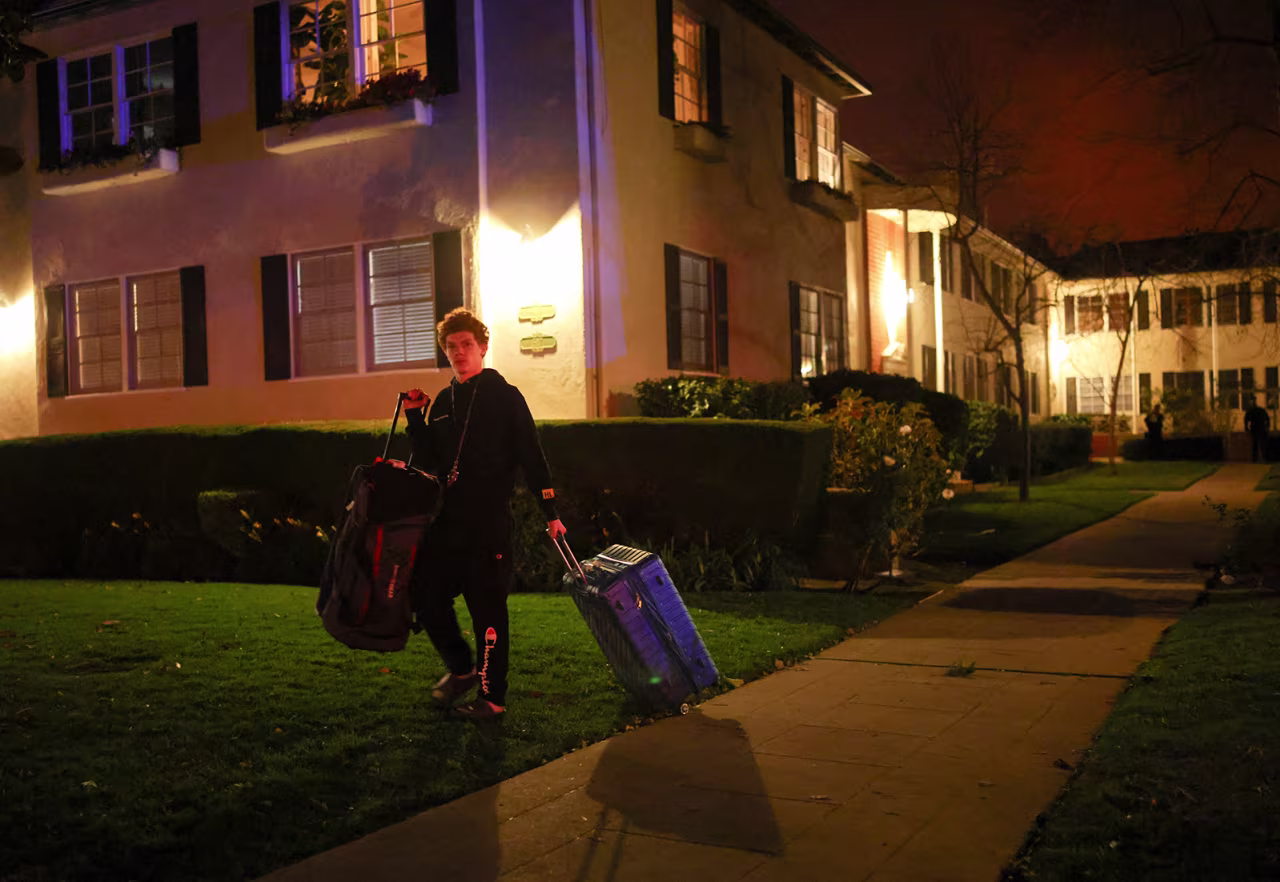 A man leaves following an evacuation order as a wildfire burns in the Pacific Palisades neighborhood on January 7.