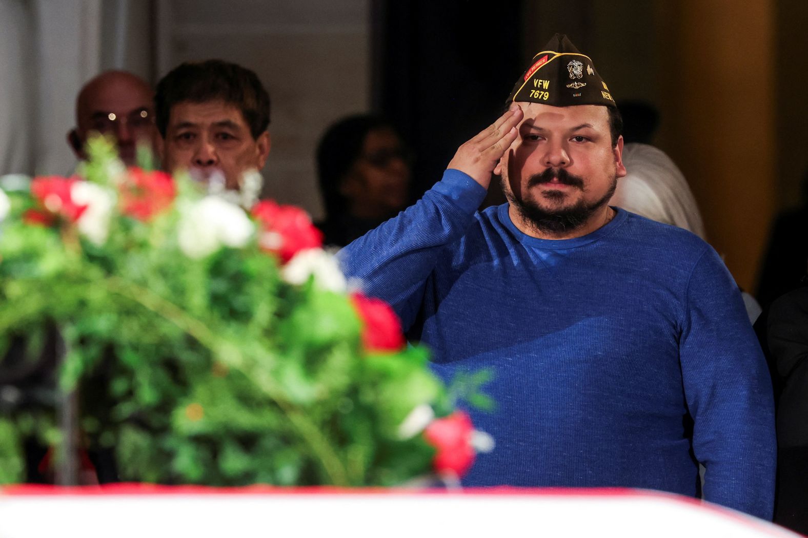 A member of the public salutes Carter's casket on January 8.