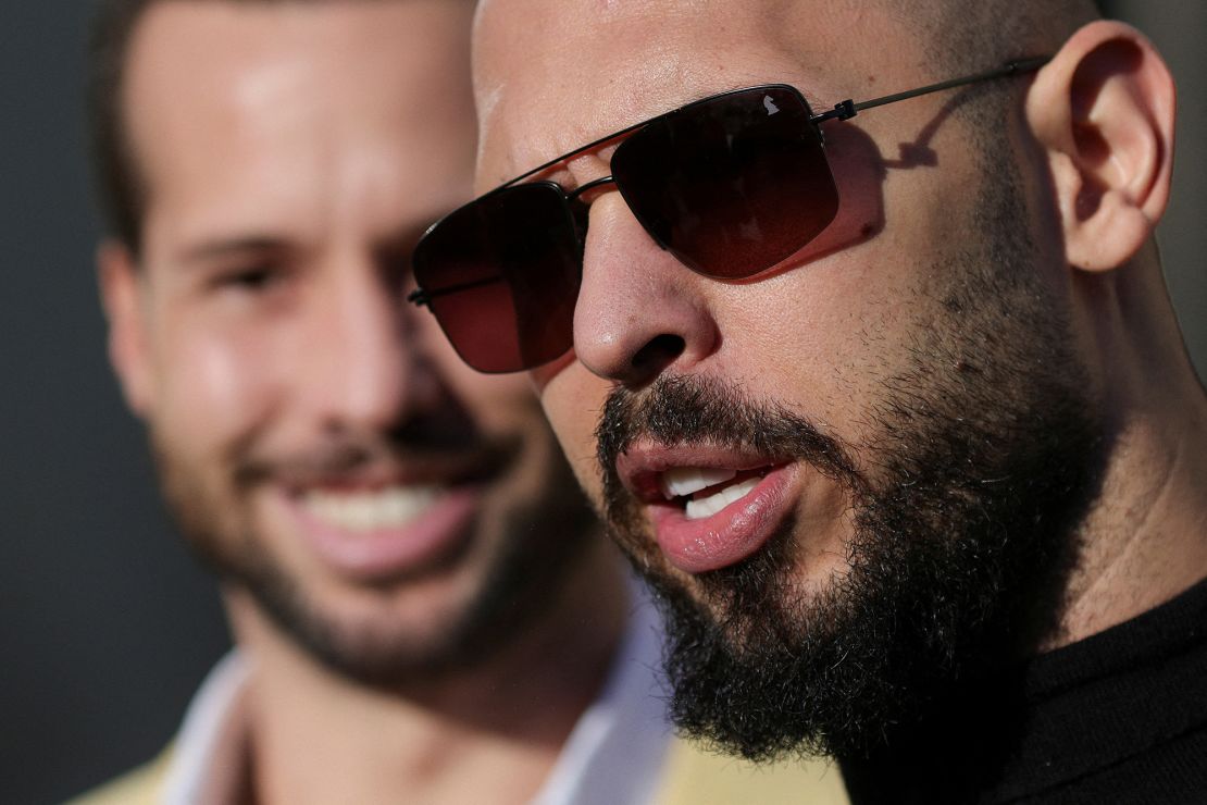 Andrew Tate talks to the media alongside his brother after exiting a courthouse in Bucharest, Romania, on January 9.