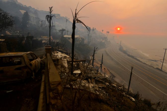 The sun rises over the Pacific Palisades neighborhood of Los Angeles on Thursday, January 9. The area has been devastated by the Palisades Fire.