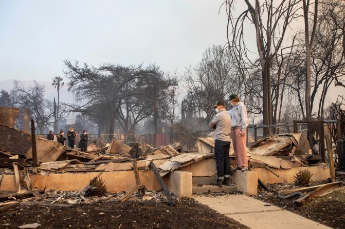 People return to the home after it has been burned down by wildfires in the Los Angeles area, at the Eaton Fire in Altadena, California, U.S. January 9, 2025. REUTERS/Ringo Chiu