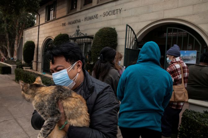 Edgar Hernandez waits outside the Pasadena Humane Society to shelter his cat after evacuating his home in Altadena.