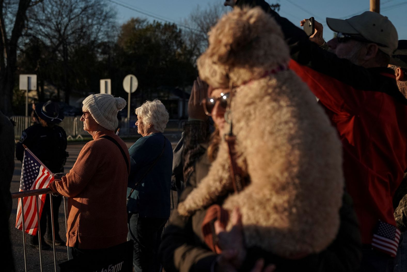 People wait for the motorcade to pass through downtown Plains, Georgia.