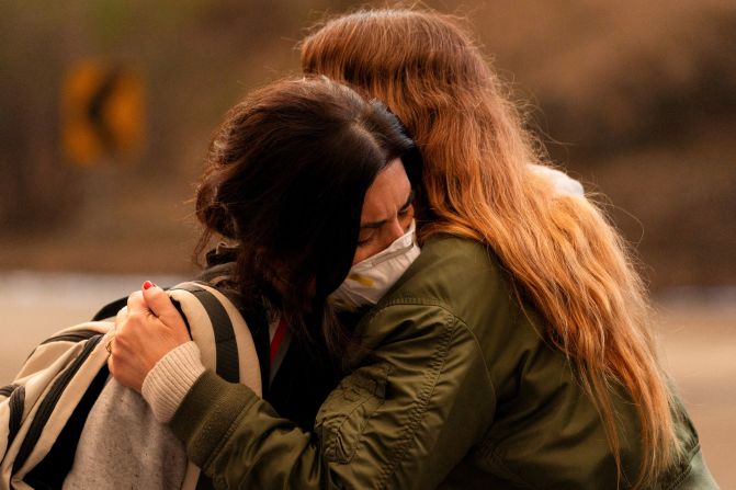 Paula Tapia hugs Katja Schmolka, who lost her home in Pacific Palisades.