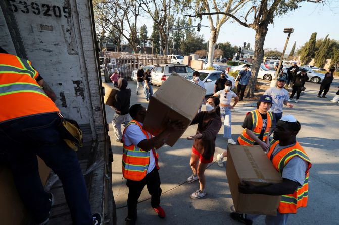 Volunteers help unload supplies to be distributed to people in Pasadena.