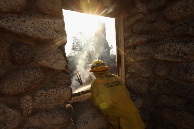 A firefighter surveys a hotspot in Altadena.