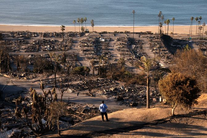 A utilities worker views damage from the Palisades Fire, in the Pacific Palisades neighborhood of Los Angeles, on Sunday, January 12.